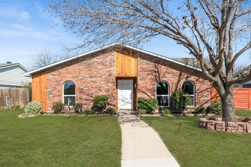 Step into this beautifully updated 3-bedroom, 2-bath home that blends modern finishes with timeless style. Located just minutes from Lake Lewisville, Grandscape, and Nebraska Furniture Mart, this home offers both convenience and comfort.

From the curb, you're welcomed by a warm brick and cedar facade, mature tree, and freshly landscaped yard. Inside, you’ll find an open layout with light wood flooring, custom rustic beams, and built-in shelving that adds charm and functionality. The kitchen boasts newly painted cabinetry in a soft modern hue, granite countertops, a sleek tile backsplash, and stainless steel appliances—all flowing into a bright dining area with French doors leading to the backyard.

Both bathrooms are fully upgraded with spa-like walk-in showers, marble-inspired tile, new vanities, and wood-accented ceilings for a designer touch. Outside, enjoy a private backyard retreat with a new horizontal plank fence, lush green space, and a covered pergola—perfect for hosting or relaxing.

Everything in this home has been carefully selected for comfort and style, making it truly move-in ready.