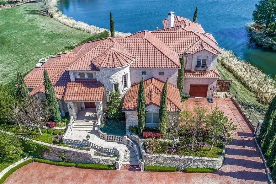 Stunning Mediterranean style, one owner custom home in gated community situated on beautiful lake lot. 5 Bedrooms, 5 and 1 half Bath, 3 car garage. Formal living dining combination, family room, study, kitchen, and master bedroom all have lake view. Gourmet kitchen with commercial grade appliances, built-in MIELE coffee-espresso machine, wet bar and wine cooler, wood floors throughout, equipped and furnished media with natural wool carpet, game room, gated driveway. Relax or entertain your friends in lake front backyard with outdoor living and infinity edge salt water pool. His and Her Walk In closets, cedar closet, steam shower with hydro massage in master. ALL OF THIS 10 MINUTES FROM TOYOTA, DALLAS COWBOYS AND LIBERTY MUTUAL and PGA. MUST SEE. Cypress trees have been removed and a home has been built on the empty lot next door.