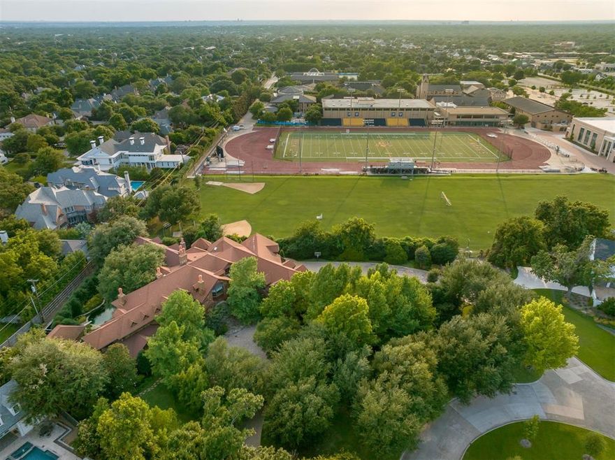 Sited on 1.39-acres connected via private gate to the prestigious St. Mark’s School, sits 6300 Brookshire Drive, a timeless estate of uncompromising craftsmanship. From the winding, tree-filled approach, this commanding 13,457 square foot home evokes a true sense of arrival and prominence. Custom built by the sole owners with no expense spared, the home boasts rich materials like mahogany hardwoods, hand-selected stone, and reclaimed wood accent details.

An entertainer’s dream, the home has lovely formal spaces that flow with ease and grace and include butler's pantry, catering kitchen and a well-equipped serving bar. At the heart of the home, and the center of everyday living, is a comfortable eat-in kitchen that flows into a family room and adjacent media room - perfect for sporting events or movie nights.

A first-floor guest suite with full bath and kitchenette offers ideal accommodations. The expansive primary suite above has an exercise room, private balcony with hot tub and flows through a wet bar into an exceptional living room with fireplace. Six additional bedrooms, including one separated for an au pair, span the second level, as well as a large study, game area, and ample storage.

The grounds are private and serene, encased in mature trees, lush garden spaces, and stone walking paths. The covered outdoor loggia features a fireplace with a hanging firebox inspired by Marjorie Merriweather Post’s Adirondack retreat and overlooks the pool and spa. There is a separate cabana large enough to use as a golf simulator with access to an outdoor pool bath. Outside of the five garage bays, a large motor court doubles as a hard surface play area. Through the back gate, the St. Mark’s campus extends your domain, offering green space, security, and world-class amenities steps from your door.

With its rare combination of stature, scale, and location, this estate offers a once-in-a-generation opportunity to create your legacy in the heart of Preston Hollow.