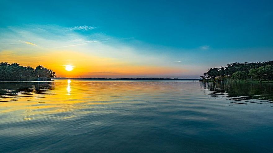 Gorgeous 1+ acre waterfront lot on Lake Bob Sandlin. Bring your own builder! Plans have been completed by an architect and owner will sell if interested. At the bottom of the newly installed steel lake wall you will find a sandy bottom for wading and playing in the water.  This amazing lot offers 275 feet of shoreline and the views of sunsets are amazing! Septic system is required when building.