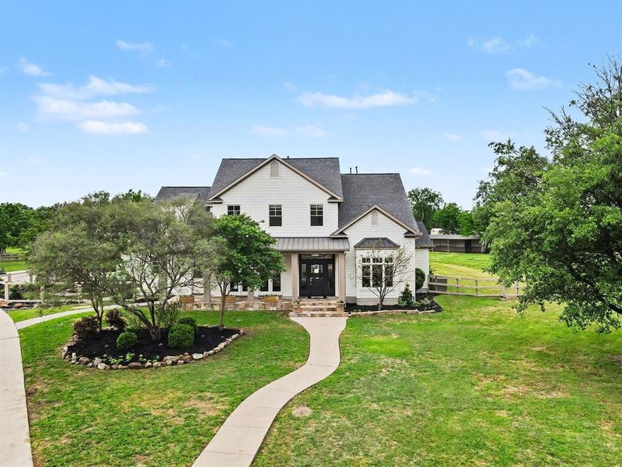 Rare opportunity to own more than 3.27 acres in Plano’s coveted Ranch Estates, where no HOA, horse-friendly acreage, and direct access to Bob Woodruff’s equestrian trails create one of Plano’s most distinctive country-in-the-city settings. Beautifully updated and extensively improved, this custom home offers more than 4,500 square feet of refined living space with soaring ceilings, rich hardwoods, fresh interior paint, updated lighting, and a bright, open layout designed for both everyday living and entertaining. The well-appointed kitchen features a 6-burner gas range, double ovens, built-in refrigerator, oversized island, and an exceptional walk-in butler’s pantry. Walls of windows fill the main living areas with natural light and frame stunning views of the pool, mature trees, and surrounding pastureland. The first-floor primary suite is a true retreat with a spacious bath and thoughtful updates, while upstairs offers generous secondary bedrooms, updated baths, and flexible living space. Outside, more than 3,000 square feet of patio and covered outdoor living space surrounds the home and pool, creating an ideal setting for entertaining, relaxing, and taking in the wide-open backdrop, while recent landscape improvements further enhance the property’s presentation. Equestrian buyers will especially appreciate the 4-stall horse loafing shed and direct access to the 1,000-acre Bob Woodruff Equestrian Park and Nature Preserve, all within Plano ISD and just minutes from the everyday convenience of city living.