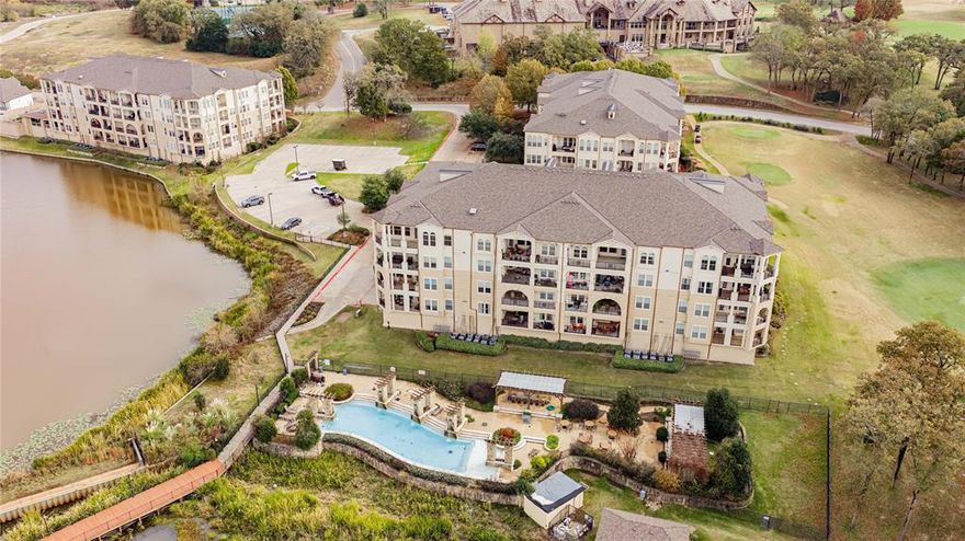 The ABSOLUTE BEST VIEW with not one, but TWO balconies!! One overlooking the beautiful lake, and the other overlooking Hole Number 1! This is truly living in the lap of luxury. Many high end features including Brazilian hardwood floors throughout, 48 inch gas cooktop and double oven, exquisite fixtures, new tile in kitchen and baths, new bathroom cabinets, spa in master bath with huge walk in closet, and brand new remote electric shades on all windows and patio. Just about everything in this condo has been upgraded including the water heater, refrigerator, microwave, AC unit, and ceiling fans. This condo comes with 2 assigned parking spaces in parking garage. Community Features: 40,000 ft Clubhouse, GolfProShop, casual dining at the Marina in the Blue Heron Restaurant, tennis, pool, spa, yoga, pickle ball and boating round out your active lifestyle choices. There is also a personal Tesla charging station.