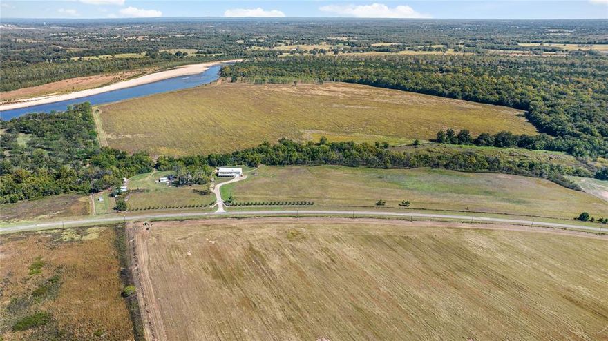 Seldom does a 1,270-acre tract along the Red River come available. With 2.2 miles of Red River frontage, it’s got the space, the water, and the privacy to do just about anything—whether you’re farming, hunting, or just looking for a solid investment. The land includes 140 acres of farmland and has frontage on FM 410, with a gated entrance that keeps things secure and quiet. The center piece improvement is a massive 8,000-square-foot barndominium that’s built for both work and entertainment. It’s got a full shop and living quarters with six bedrooms, six full bathrooms, and two half baths. Plenty of room for family, guests, or a crew. The hunting here is excellent, with deer, turkey, half a dozen duck sloughs, and other wildlife all over the place thanks to the river-bottom terrain. If you’re looking for a recreational ranch that’s ready to go and built to last, this one checks all the boxes.

FACTS
- Red River County Texas
- 2.2 miles of Red River frontage
- FM 410 frontage
- 140 Acres of farmland
- 1130 Acres of mixed timbers, duck sloughs, and wildlife green patches

IMPROVEMENTS
- 6000 sqft. Residence
- 6 bedrooms
- 6 full baths
- 2 half baths
- Attached 40x40 shop
- Equipment Storage

WILDLIFE
- Whitetail deer
- Ducks
- Geese
- Hogs
- Bobcat
- Coyotes
- Catfish 

Disclaimer: All information provided herein was acquired from sources deemed reliable and is believed to be accurate. However, we do not warrant its accuracy or completeness and recommend that every item of interest be independently verified by Purchaser.