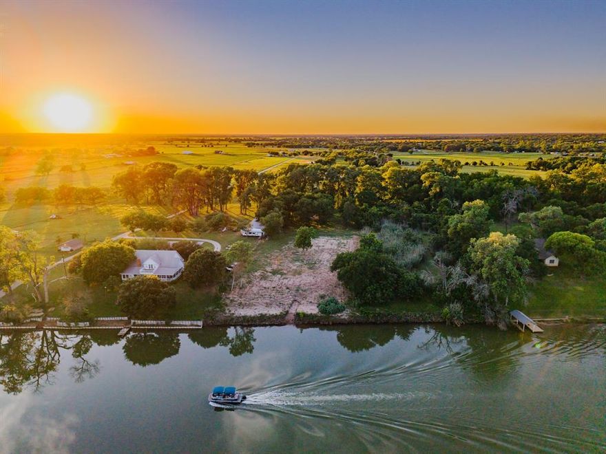 Incredible 10-acre Brazos River frontage just off Buster Chatham Rd in Waco! This is one of the most scenic and navigable stretches of the longest river system in Texas. With the right setup, you could boat all the way to Baylor’s McLane Stadium or dock at Slow Rise Pizza—making this one of the most recreationally unique stretches of riverfront in Central Texas. Hardwood trees line the private driveway, opening up to towering cottonwoods near the water’s edge. The river here is postcard-perfect and remains calm thanks to the sheltering banks and trees, making it ideal for skiing, wakeboarding, paddleboarding, or just floating. A large custom shop sits well out of the floodplain and includes three oversized bays and one XL bay perfect for RV storage. Inside, a two-story living space offers the perfect setup for weekend getaways or full-time use. The interior features epoxy-coated concrete floors, granite countertops, abundant cabinet storage, and two spacious bathrooms—each with large showers and dual vanities. The upstairs bathroom also includes a walk-in closet. Two staircases—an interior spiral and a wide exterior staircase—make access and furniture moving a breeze. Power is run throughout the shop, along with strategically placed air lines. The soil on this tract is incredibly fertile, a byproduct of the Brazos River basin’s rich sediment, supporting lush grasses and native trees. If gardening is your thing, the potential here is unmatched. Whether you’re a local looking for a private recreational haven, a Baylor alum wanting to boat into town, or someone seeking a rare riverfront estate to build your dream home—this property is truly a must-see. Just 10–15 minutes to downtown Waco and Baylor. Call for a private tour.