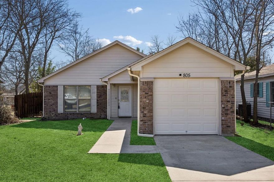 Welcome to 805 Phillips Street, a well-designed brick and siding home built in 2016 offering 1,237 square feet of comfortable living in Cleburne. This three-bedroom, two-bath residence features an open layout connecting the living room, dining area, and kitchen into a bright space filled with natural light. Wood-style tile flooring runs through the main areas for durability and easy care. The kitchen includes stainless steel appliances, granite countertops, cabinets, a pantry, and a large island suited for daily use and entertaining. The dining nook flows into the living room, creating a relaxed setting for gatherings. The primary bedroom offers a walk-in closet and an ensuite bath with granite surfaces and updated fixtures. Two additional bedrooms are generously sized and include brand new carpeting with superior padding. The laundry area is conveniently located near the bedrooms. A new architectural roof was installed in February 2026, and the home features an upgraded 200-amp electrical service designed to support modern needs. Outdoor enhancements include a house-wide covered patio extension that provides shade throughout the year. Trees along the property line were removed to allow for a new wooden fence with extra-wide gates opening to the alley, improving access and privacy. The insulated garage with a window unit offers flexible use as a hobby or workspace. The property sits across from the elementary campus with easy access to Chisholm Trail Parkway and close proximity to downtown Cleburne dining, shopping, and the new HEB. This home offers stainless appliances, updated bath fixtures, open living areas, and a practical layout suited for everyday life. The backyard provides room to relax or entertain, and the location allows quick connections to major routes. Clean and move-in ready, this property blends modern updates with comfort and value.