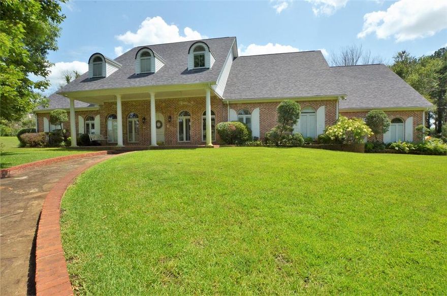 Traditional brick home is stunning and is surrounded by lush green grass and manicured landscaping. Once inside you are greeted with the large open living space with soaring ceilings, arched doorways, thick crown molding, and rich hardwood floors. Exquisite master suite is roomy with beautiful built-ins, double french doors to the patio, separate vanities and walk-in closets, jetted soaking tub, and walk-in shower. Upstairs offers ample space for your family and guests with both bedrooms offering en-suite baths. Entertain friends and family on the extended patio for cookouts. Backyard has awesome space for a future pool, play area, and space for kids and pets to run and play.