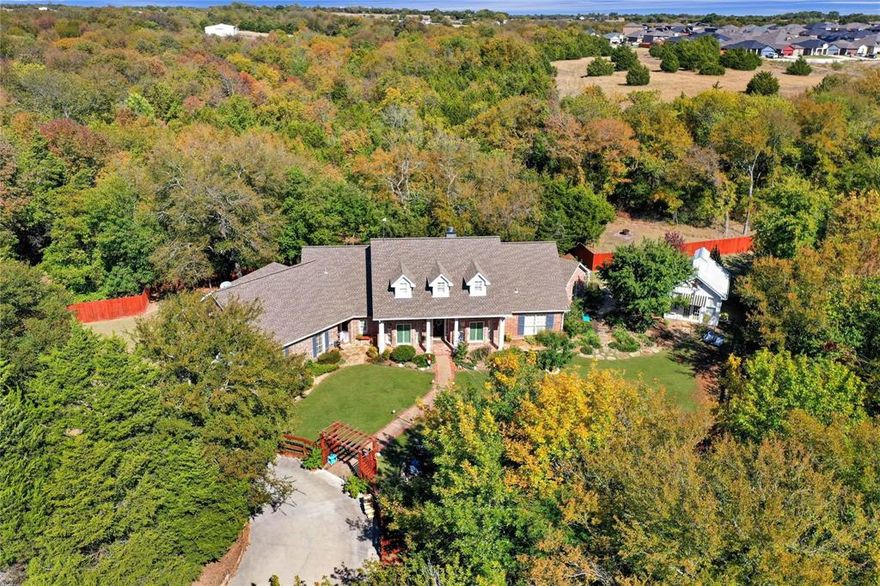 Nestled on 3.417 acres of heavily treed land in Farmersville, this stunning 3,240 sq ft home offers the perfect blend of privacy, space, and modern comfort. With 4 bedrooms and 4 bathrooms—including two primary suites—this thoughtfully designed layout is ideal for multi-generational living or hosting guests.
Step inside to an open floor plan featuring beautiful wood and tile flooring, two spacious dining areas, and a warm, inviting living room anchored by a stone, wood-burning fireplace. The large kitchen is a true centerpiece, complete with a generous island, white painted cabinetry, and granite countertops—perfect for both everyday living and entertaining.
A remodeled bathroom adds a fresh, updated touch, while expansive windows bring in natural light and showcase the serene, wooded surroundings.
Outdoors, enjoy peaceful country living with a charming stone patio, fire pit, and plenty of space to relax or entertain. A dedicated “She Shed” offers the perfect private office or creative retreat, and an additional storage building provides extra functionality.
Surrounded by mature trees and set back for ultimate privacy, this property delivers a rare opportunity to enjoy quiet country living without sacrificing comfort or style.