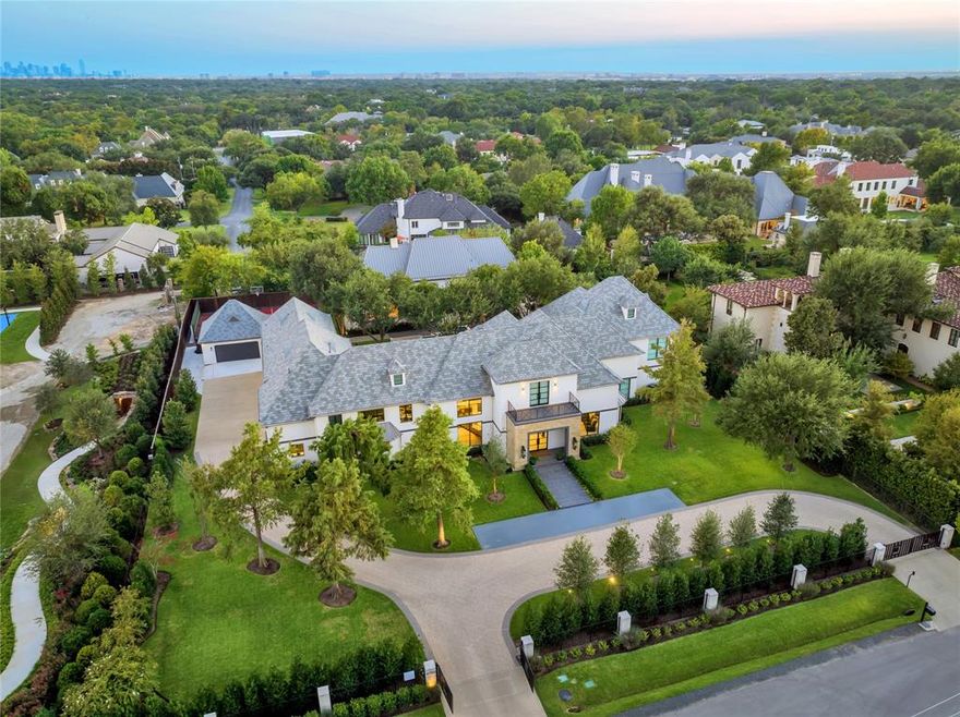 The Primary Suite has just been completely redesigned and updated. Beautifully reimagined and expanded upon in 2023-2024, this spectacular estate property is located in the sought after Strait Lane corridor of Preston Hollow. This luxury residence sits on 1.2 lushly landscaped acres gated for security and privacy, the home offers a stunningly architecturally significant 2,300 sqft pool house complete with its own living and dining areas with vaulted ceilings, two beds and two baths. A covered terrace offers a large outdoor living area with views of the 22' pool, sports court offering pickle ball as well as basketball, putting green, and grassy lawns. The main home is an entertainer's dream which remains a perfect home for an active family life. Interior spaces are flooded with natural light with expansive walls and high ceilings. First floor includes a grand foyer, formal living and dining with temperature controlled wine room, media room and family room or lounge. Gourmet kitchen includes a second catering kitchen, butler's closet and walk-in pantry. Dual level primary suite features a private outdoor spa. Four secondary bedrooms are upstairs, including accommodations and extra entertaining space. Situated at the end of Lennox Lane offering beautiful views and a dramatic approach, with quick access to Dallas' top schools, shopping and dining.