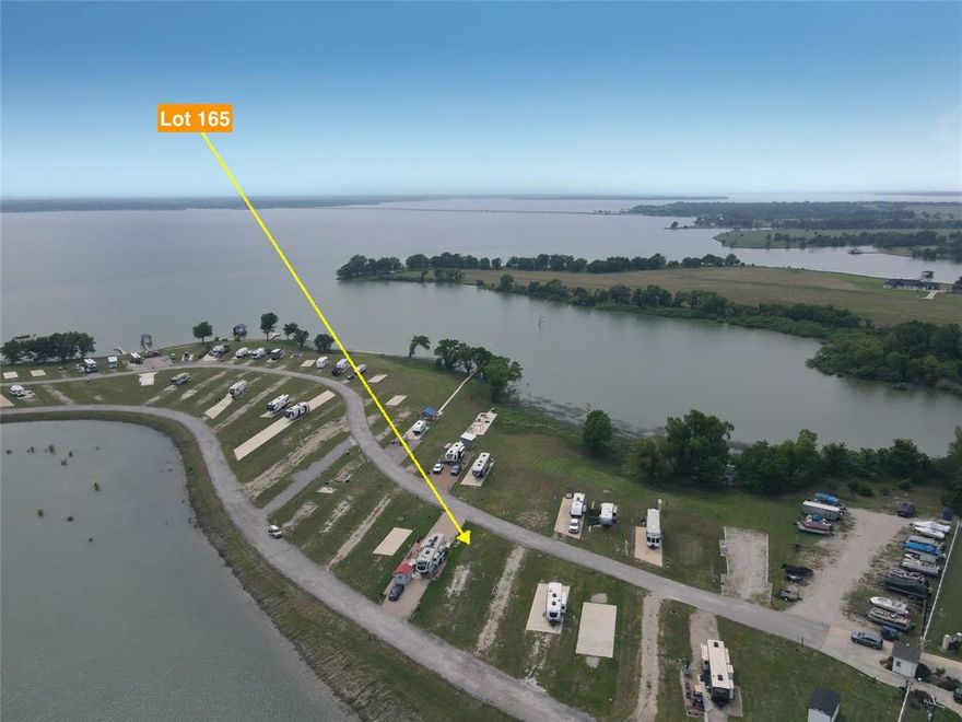 If you’ve been dreaming of a peaceful escape by the water, Lot 165 in Peninsula Point might just be the perfect place to bring that vision to life. Tucked away in a friendly and charming RV community on the shores of Richland Chambers Lake, this lot offers everything you need to start enjoying the laid-back lake lifestyle right away. The gravel driveway is already in place, so whether you’re bringing in your RV or planning to park your tiny home, access is easy—and you’ll love the relaxing view overlooking the community pond. One of the best perks? The water tap fee has already been paid, which means the lot is ready to use without the added hassle or extra cost. As a resident of Peninsula Point, you’ll have access to a great lineup of community amenities, including a gated entrance for peace of mind, a welcoming clubhouse, and a sparkling pool that’s perfect for cooling off on those warm Texas days. There’s even a boat ramp so you can easily get out on the water whenever the mood strikes, plus a playground to keep the kids entertained and an on-site laundry facility for added convenience. In addition, short-term rentals are allowed in the community, so whether you’re looking to create your own weekend retreat or generate some extra income when you’re not using it, you’ve got flexible options. Lot 165 is more than just a piece of land—it’s a chance to create your own little slice of lakeside paradise. Whether you're looking for a serene personal escape, a fun family hangout, or a smart investment opportunity, this property is ready to deliver. Come see what life by the lake could look like—you might just fall in love.