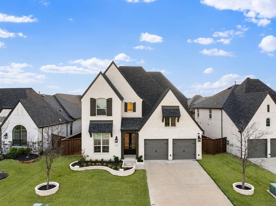 Situated in the highly sought-after Trinity Falls community, this beautifully designed home offers a refined blend of modern design and functionality with soaring ceilings, abundant natural light, and carefully selected finishes throughout. The open-concept layout features a well-appointed kitchen with quartz countertops, an oversized island, stainless steel appliances including a gas cooktop and double ovens, and a spacious walk-in pantry, all seamlessly connected to the dining area and expansive living room highlighted by a fireplace and two-story windows. The main-level primary suite provides a private retreat with a spa-inspired bath complete with dual vanities, a soaking tub, separate walk-in shower, and generous closet space. A dedicated media room creates the perfect setting for entertainment, while the oversized upstairs game room and additional flex space offer versatility for work, play, or multi-generational living. Thoughtful details including designer lighting, wide-plank flooring, a mudroom with built-ins, and a well-appointed laundry room enhance everyday convenience. Secondary bedrooms are generously sized with access to well-finished bathrooms. Residents of Trinity Falls enjoy resort-style amenities including multiple pools, a clubhouse, fitness center, scenic trails along the Trinity River, parks, playgrounds, and a strong sense of community, all within close proximity to shopping, dining, and top-rated schools.