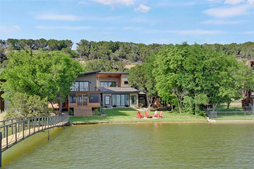 Huge price reduction at no fault of the property. Modern Chic and Classic Comfort set the mood for this impressive lakefront home with many designer touches. The Sunlit corridor leads to a comfortably appointed living space with vaulted shiplap ceilings, lovely chandelier,  gracious leather seating and an expansive glass slider offering blue water views. The eat in designer kitchen boasts gorgeous cabinetry and gourmet appliances including a sub zero like fridge. Well equipped  coffee or wine bar with built in cooler allows for ease of access from either the living or kitchen spaces. You will find Two lower guest suites off of the left wing of the home, each well appointed, one hosts a murphy bed, beautiful built in cabinets and access to a large private outdoor patio. The Upper master suite with balcony offers tranquil lake side views, large closet and ensuite bath. The right wing of the property is host to a huge den with built in bar, handsomely outfitted and perfect for lounging or shooting a game of pool. The upstairs apartment offers an ensuite bath and a full kitchenette for your guests with a large lakeside balcony sure to keep them coming back. But there is more, Enjoy the expansive lakeside screened porch for gaming, dining  or just chilling after a day on the lake offering plenty of seating. Gentle walk to covered dock with upper deck for sunbathing, 1 slip with lift and PWC lift. Turnkey and ready to enjoy! Welcome home!