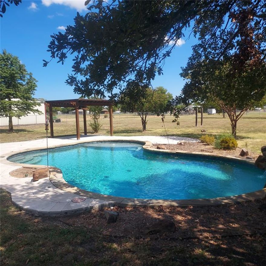 Country life but close to the city! Sitting on over an acre, right outside of city limits, this home has it all. Sunlight beams through the plantation shutters highlighting the hardwood floors throughout. The formal dining room leads right into the kitchen which is open to the livingroom and has a walk-in pantry, double ovens, granite counters with a breakfast bar and room for a table. The primary bedroom has an ensuite bath with a soaking tub, separate shower, dual sinks and dual closets. The back of the house has a HUGE bonus room perfect for game nights or movie marathons. Out back you'll have no shortage of space to entertain with the sparkling pool, covered patio, and pergola and STILL enough room to build a shop, throw the football, or just let the dogs run! You get all of this with NO HOA!!