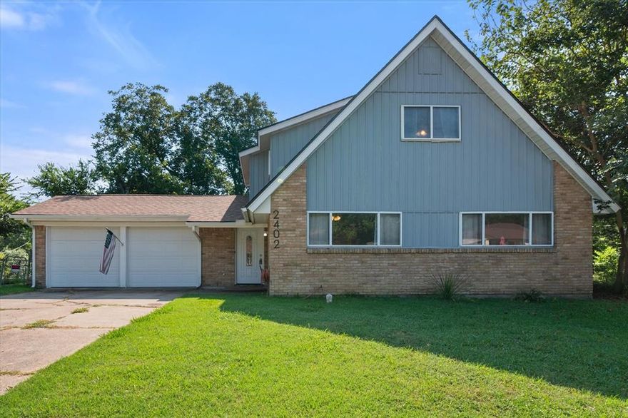 Welcome to this inviting two-story home featuring 3 bedrooms, 2 bathrooms, and a warm, open layout perfect for comfortable living. The living room boasts a beautiful brick fireplace with a classic mantle, creating a cozy focal point. Natural light pours in through the French doors leading to the backyard, seamlessly blending indoor and outdoor living. The updated kitchen offers granite countertops, stainless steel appliances, and a stylish tile backsplash, making meal prep a breeze. Upstairs, you’ll find additional living space and bedrooms, giving everyone room to spread out. Step outside to enjoy the shaded backyard with mature trees, perfect for entertaining, gardening, or simply relaxing. A two-car garage and plenty of storage add to the convenience. Located in a friendly neighborhood, this home is move-in ready and waiting for its new owners!