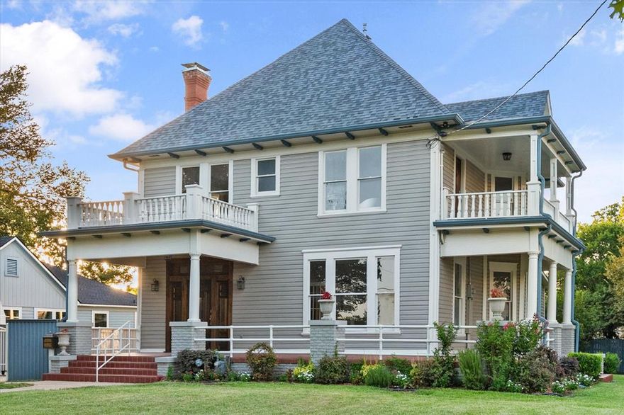 Built in 1910, this historic Carriage District home has stood as a quiet testament to early 20th-century craftsmanship and thoughtful design. Original wood floors bear the character of generations past, while substantial baseboards and classic crown molding frame each space with enduring elegance. Two fireplaces once served as gathering points, warming gracious living areas designed for both conversation and comfort. A sweeping staircase rises from the entry, setting a tone of timeless presence and architectural significance.

The home was designed with uncommon foresight, offering primary bedrooms on both the first and second floors, each with an en-suite bath—providing flexibility and privacy well ahead of its time. Tall ceilings, large rooms, and abundant natural light enhance the sense of scale and warmth throughout. Covered porches on both levels offered places to slow down and enjoy the rhythm of the neighborhood, a tradition that still feels possible today.

Set back from the street, a gated driveway leads to the garage, offering privacy and added security while preserving the home’s stately presence. Modern updates include Bosch stainless steel appliances, a 6-burner gas cooktop, and double ovens, blending contemporary convenience with historic charm.