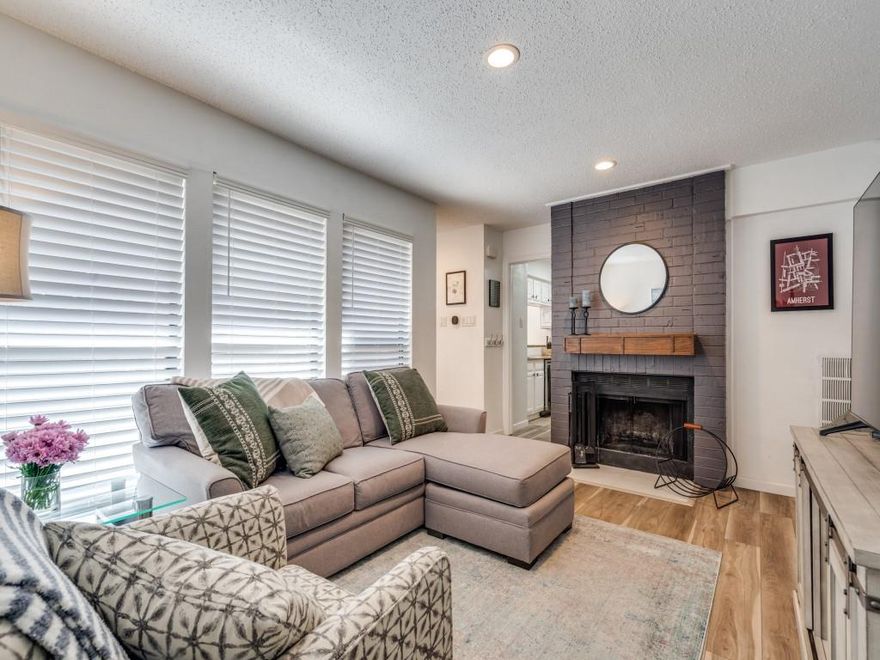 Don't miss this incredible opportunity for a well-maintained North Dallas condo offering easy access to major highways, shopping, and restaurants. Seller has appointed the home with many recent upgrades including new HVAC, high-end appliance package, all-new bathroom fixtures, and LVP flooring throughout. Spread across two stories, the ground-level features a cozy living room with fireplace, dedicated dining room with high ceilings and large windows, an updated kitchen, laundry space, and half bath. Upstairs, you'll find two bedrooms, including a spacious primary with ample natural light, large bath with dual sinks, and walk-in closet. The secondary bedroom also features an en-suite bath with a newly tiled shower and glass door. The home offers convenient dual entry - with a welcoming front patio that acts as an outdoor living space, and a back entry door right off your two reserved covered parking spaces.
