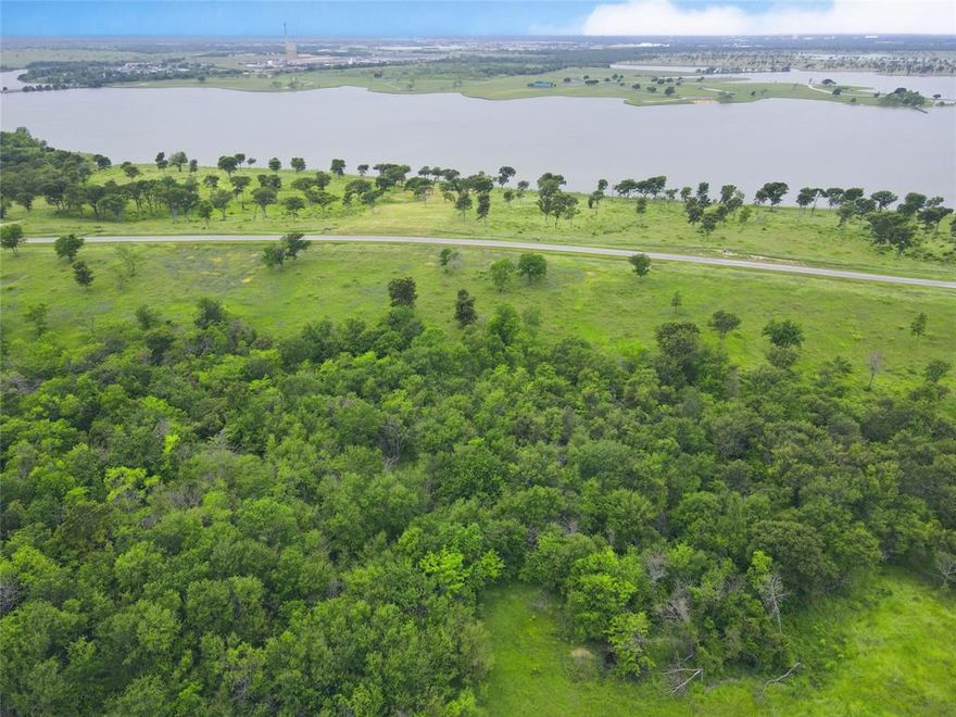 This 3+acre lot in Barefoot Bay on Lake Halbert gives you all the fun of the lake combined with the convienence of town just a few minutes down the road to Corsicana. This lot is 3.19 acres located in a quiet cul-de-sac that is cleared near the street, with a nice stand of mature shade trees at the rear offering both privacy and shade. You'll find plenty of space to build that dream lake house, plus extras like a outdoor entertainment area or a string up some hammocks under all your new trees! Worried about being offwater? Don't be...the listing price INCLUDES your own boat slip (#20) down in the private Barefoot Bay slips so getting out on the lake is a breeze! Barefoot Bay is a wonderful gated community with rolling hills on the shores of Lake Halbert. Tons of community amenties too...including a clubhouse with a pool, fitness room and meeting spaces. In additition to your own boat slip, there is a private boat ramp and firepit area! So welcome to the lake, a world away from worries!