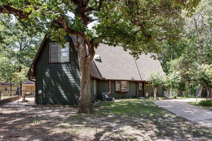 Welcome to your lakeside escape in Loon Bay at Cedar Creek Lake where relaxed living, natural beauty, and unforgettable sunsets come together.

This charming two story, three bedroom, three bath home offers the perfect balance of comfort, functionality, and outdoor space, set on a generous tree shaded lot that stands out from nearby newer homes. Enjoy a peek a boo waterview from the front yard, adding just the right touch of lake charm. A circular front drive adds convenience and curb appeal, while the expansive lot provides room for RVs, boats, and all your lake lifestyle essentials.

Inside, soaring ceilings and a spacious living area anchored by a cozy fireplace create an inviting space to gather. The main level features a private primary suite and two full baths. The kitchen with newer appliances flows into the dining area with a bright bay window.

Upstairs offers two additional bedrooms, a full bath, and a versatile space with a built in desk that is ideal for guests, a home office, or additional living.

A standout feature is the climate controlled solarium, perfect for year round relaxation while enjoying peaceful views.

Step outside to your private backyard retreat, complete with a shade awning and a firepit ideal for entertaining or unwinding. The large lot offers flexibility rarely found, with room for outdoor living, storage, and recreation.

Additional highlights include RV or boat parking, easy turnaround, and large metal storage building with covered parking, perfect for a workshop or storing lake gear.

Located just moments from the water in a quiet neighborhood, residents enjoy POA amenities including a private boat ramp and park with playground and swimming area. Conveniently close to dining, shopping, and year round activities.

Whether you are seeking a full time residence or weekend getaway, this property delivers space, flexibility, and the true lake lifestyle, enhanced by stunning sunset views you will enjoy night after night.