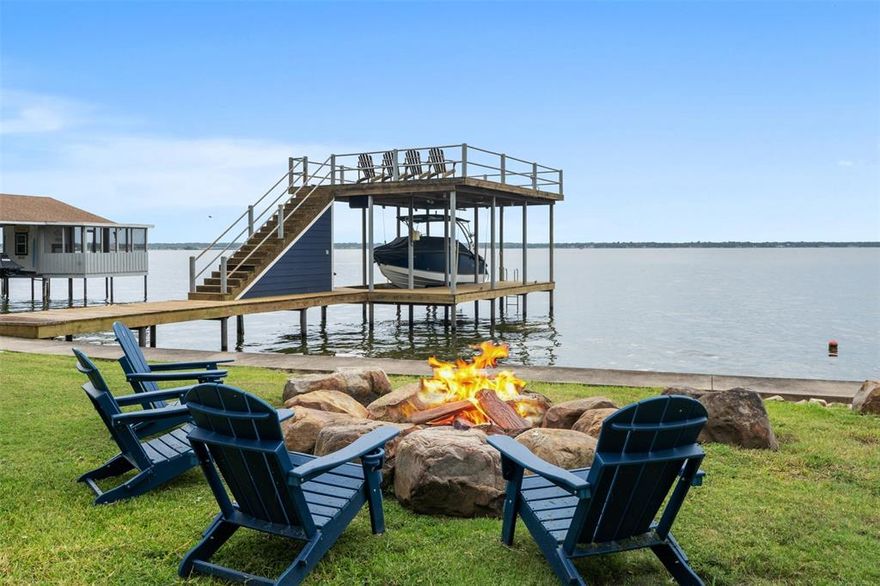 Stunning Wide Open Water Retreat with breathtaking sunsets that bring the beauty of the lake right to your doorstep. A newer boathouse with a Jet ski lift plus an upper deck to lay out in the sun and a waterside fire pit to roast marshmallows is where you will want to be. This beautiful lake home comes Furnished so all you need to bring are your clothes and a toothbrush. This home was totally remodeled in 2017 and the boathouse and retaining wall was put in also. The home features large windows throughout flooding each room with natural light and framing the beauty of the lake while the private dock gives you instant access to swimming, fishing and boating. All rooms in the home make for a cozy retreat and showcase panoramic water views from nearly every room leaving nothing out. Whether your hosting family and friends or enjoying a quiet weekend alone, the open water becomes part of every moment so memories can be made. This home is perfect for full time living, a vacation home or investment property. Short term rentals are allowed at this time. Take a look and see for yourself all the beauty this home offers.