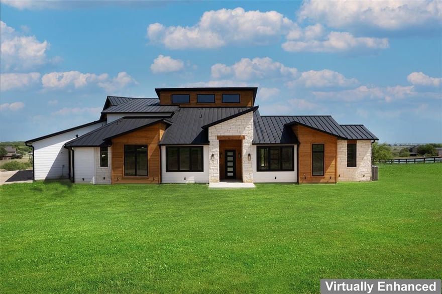 COMPLETED and ready for move-in. Hill Country Luxury Modern on 5 acres with over 3,600 sq ft of meticulously designed living space, perfect for family gatherings or entertaining. Soaring 20-foot tall ceilings throughout the main living areas, creating an open, airy ambiance. 4 large bedrooms, each featuring its own en-suite bathroom, plus 2 additional half baths for guests. Gourmet kitchen equipped with top-of-the-line appliances, a full-size pantry, and a large island. Luxurious master bedroom features a private patio, Upstairs game room is ideal for family fun, complemented by a large balcony to enjoy panoramic views.
Energy Efficient 2x6 construction, spray foam insulation, energy-efficient appliances, and Energy Star-rated central heat and air conditioning for year-round comfort and savings. Oversized garage with room for vehicles, storage, or a workshop.  Easy access to I-35W, Denton, Alliance, Hwy 114, retail and entertainment.