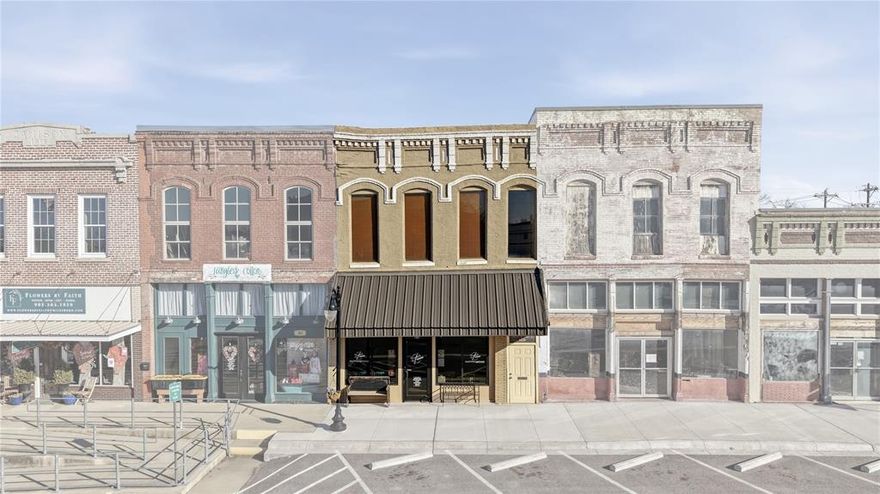 Located in the heart of historic downtown Whitesboro, 107 & 109 E Main Street presents a rare opportunity to own a true cash-flowing investment property in a prime Main Street location. With strong visibility, established tenants, and flexible office space, this property offers both stability and upside potential. The downstairs at 107 E Main is approximately 1,800 square feet and is home to a well-established, long-term tenant operating a full-service hair salon. The space is thoughtfully laid out and includes a private bathroom, dedicated washer and dryer area, and convenient alley access. Public parking along Main Street provides excellent exposure for the business, while additional alley access offers convenient parking for employees and customers, as well as proximity to Whitesboro’s popular food truck park. Upstairs, you’ll find an additional approximately 1,880 square feet with its own private staircase entrance from Main Street, plus a secondary staircase at the rear of the building. The upper level is configured into five private office suites available to lease by the room, creating multiple income streams. A shared commons area can serve as a client waiting area for tenants or be rented separately on a daily basis for meetings, events, or collaborative workspace needs. This flexible layout appeals to small business owners, remote professionals, and entrepreneurs seeking an affordable downtown presence. With long-term tenants already in place and income-producing office space above, this is a turnkey investment in one of Whitesboro’s most charming and steadily growing commercial corridors. Own a piece of historic downtown Whitesboro while generating consistent rental income from day one.