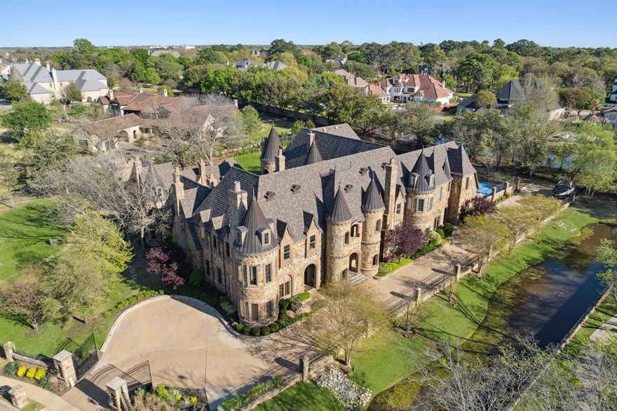 In the heart of Southlake, behind tree-lined streets and quiet prestige, stands your modern castle at 1161 La Mirada Court. Set on nearly two acres, this 13,922 sq ft estate blends grandeur with warmth and imagination. Built in 2010 and exquisitely reinvented in 2021, it showcases artisan finishes and luxe accents from Vanderpump Alain, bringing couture detail and sculptural beauty into every room. With 7 bedrooms and 12 baths, the home offers dramatic architecture balanced by inviting, intimate spaces, all within award-winning Carroll ISD. The first-floor primary suite is a serene retreat with a spa-like bath and stunning two-story boutique closet. A grotto spa and pool flow seamlessly indoors to out, creating resort-style living alongside a private tennis court and elegant 2-bedroom guest house. Every detail whispers romance—this is more than a home; it is a Southlake legacy.