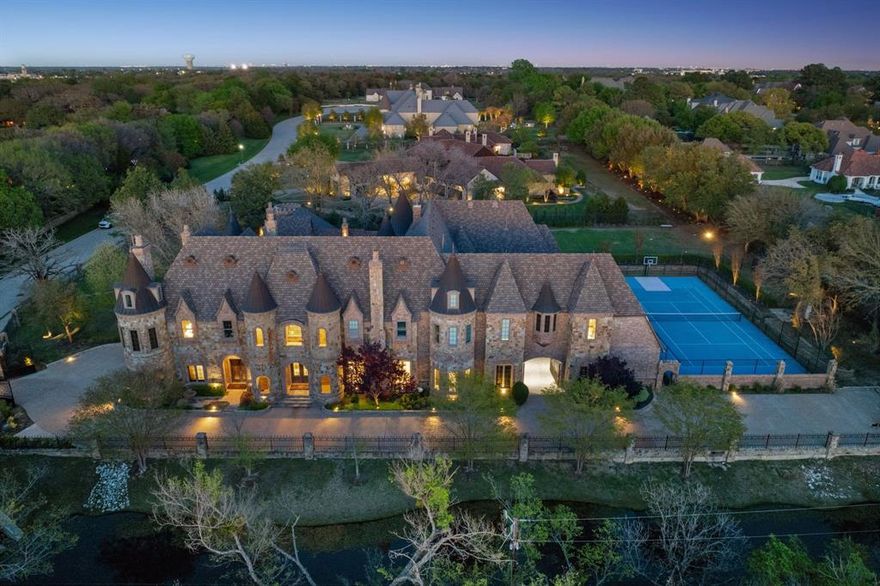 In the heart of Southlake, behind tree-lined streets and quiet prestige, stands your modern castle at 1161 La Mirada Court. Set on nearly two acres, this 13,922 sq ft estate blends grandeur with warmth and imagination. Built in 2010 and exquisitely reinvented in 2021, it showcases artisan finishes and luxe accents from Vanderpump Alain, bringing couture detail and sculptural beauty into every room. With 7 bedrooms and 12 baths, the home offers dramatic architecture balanced by inviting, intimate spaces, all within award-winning Carroll ISD. The first-floor primary suite is a serene retreat with a spa-like bath and stunning two-story boutique closet. A grotto spa and pool flow seamlessly indoors to out, creating resort-style living alongside a private tennis court and elegant 2-bedroom guest house. Every detail whispers romance—this is more than a home; it is a Southlake legacy.