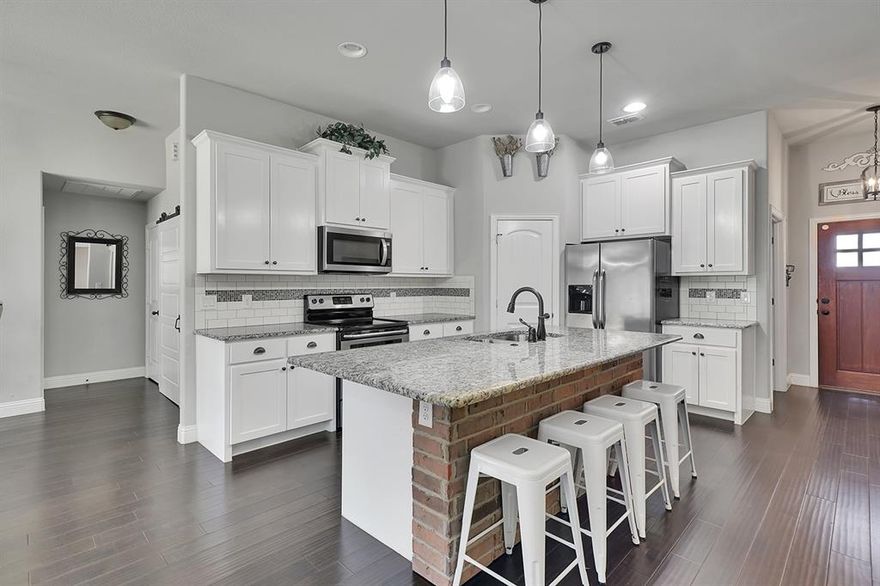 Use of Preferred  Lender will offer to pay .75 points of buyer’s closing costs. Call TODAY to see if you Qualify! 
Welcome to your dream home! This ultra-custom residence features a thoughtfully designed split floor plan with 4 bedrooms and 2 full baths, complemented by a dedicated office space. As you step inside, you're greeted by stunning hardwood floors that flow seamlessly through the entry, office, and living areas.The heart of the home, the kitchen, boasts elegant granite countertops, stainless steel appliances, and a spacious working island with additional seating, highlighted by a charming brick accent front. This culinary haven opens up to an inviting dining room and a living room bathed in natural light, thanks to windows that stretch across the back wall.The living room is anchored by a coordinating brick fireplace, creating a warm and welcoming atmosphere that's perfect for entertaining. Tucked away behind the living room, you'll find three generously sized secondary bedrooms, each equipped with ample closet space, along with the first full bathroom.Retreat to the large master suite, conveniently located behind the dining room. This tranquil space features beautiful trey ceilings, picturesque views of your backyard, and a luxurious ensuite bathroom with split double vanities, a tiled walk-in shower, and a spacious walk-in closet.Step outside to enjoy your covered back porch, where you'll have plenty of room for entertaining guests and enjoying outdoor activities. This home truly combines elegance and functionality, making it the perfect place for both relaxation and entertaining. Don’t miss the chance to make this beautiful property your own!