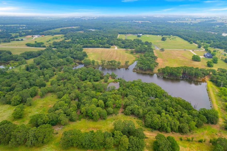 Stunning Ranch in Collinsville, Texas. 41.908 Acres of beautiful, wooded and improved pastures with a huge, stocked pond. This pond is stocked with Bass, Bluegill, Crappie and many more species of fish. Abundance of wildlife. Enjoy sitting on the dock with amazing sunset views! Beautiful modern shop home built in 2022 with luxury interiors and cedar accents throughout. This home offers 2 bedrooms, 2.5 baths, 2 living areas, game room, office and foam insulated shop garage. Outdoor living area with covered patios. Wildlife exemption in place for lower taxes.  Outside city limits. Just 20 minutes from the Dallas North Pkwy. 1 hour from DFW Airport. Tioga ISD.