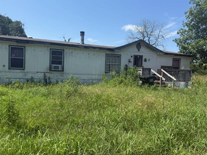 Beautiful Acreage with Endless Potential in Paris, Texas!

Welcome to your own slice of paradise nestled on 18.4 acres in the peaceful countryside of Paris, Texas. This unique property features a 3-bedroom, 2-bath manufactured home — perfect for weekend getaways or temporary living while you build your dream home. The true value lies in the land and its many features.

Enjoy a fully stocked pond ideal for fishing, 3 exterior water spouts for convenient irrigation, and a spacious barn ready for storage, equipment, or livestock. There's also a chicken coop for your flock and a carport to protect your vehicles. For RV enthusiasts, the property includes a pad complete with electrical and water hookups.

Wildlife is abundant, making this an excellent property for hunting or simply enjoying nature. With plenty of room for livestock and additional development, this land offers endless opportunities for farming, recreation, or building your custom home.

The home does need some work, but the surrounding acreage, utilities, and existing structures make this a rare find with incredible potential.

Don’t miss out on this versatile property — schedule your private tour today!