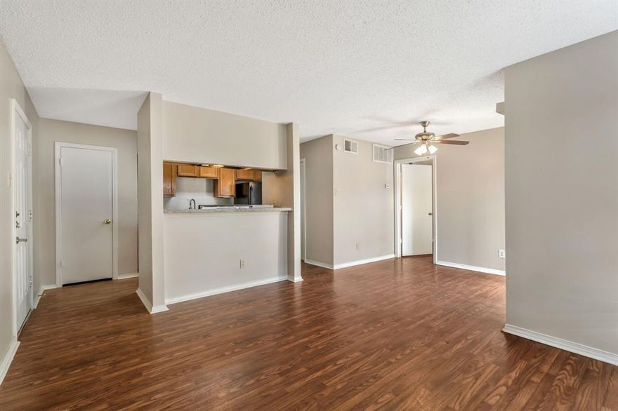 Charming 1-bedroom condo in gated Cimarron Court, priced to sell and ideally located in North Dallas. This 1st floor unit features real hardwood floors throughout, a bright open living area with large windows, and a private balcony for outdoor relaxation. The kitchen offers abundant cabinet space, refrigerator included, and appliances with dishwasher, range, and vent hood. The bathroom provides an extended vanity, ample storage, and a tub-shower combo. A washer and dryer are also included, making this home truly move-in ready. Residents enjoy access to multiple community pools, gated entry, and assigned parking. Conveniently situated near major highways, shopping, dining, and entertainment, this property offers an excellent blend of comfort, convenience, and value—perfect for an owner-occupant or investor seeking a strong North Dallas location.