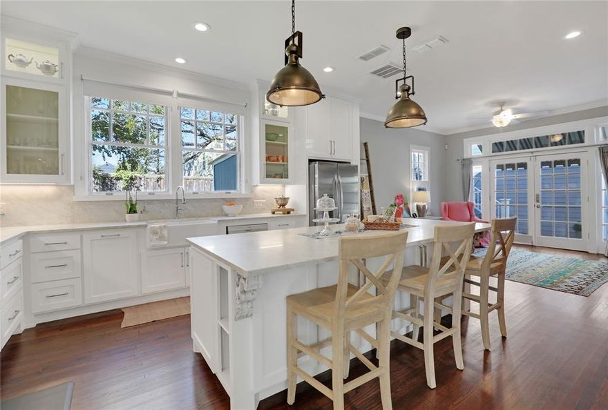 HISTORIC MCKINNEY's JACKSON-ATKINSON house, built in 1914, has been beautifully renovated and is situated on one of McKinney's most desirable streets: 1204 Tucker Street. The corner lot provides an expansive front yard and a newly constructed (2023) 730 sq.ft. oversized, detached garage facing the side street. A 600 sq.ft. CARRIAGE HOUSE is situated atop the garage, featuring a balcony overlooking the pool and courtyard. A rebuilt and widened walkway, constructed with reclaimed red bricks, leads to the inviting wrap-around porch and front door. The recently remodeled interior boasts a designer kitchen ideal for entertaining, complete with a large center island, ample cabinet storage, and Carrara Marble countertops. It includes a Bertazzoni 5-burner cooktop convection oven and vent hood, a large farmhouse sink and faucet, custom ceiling-high kitchen cabinets with inset lighting, and a spacious walk-in pantry. Additionally, there is a cozy sitting area off the kitchen and French doors that lead to the side porch and a tranquil POOL with spa. Both the primary and downstairs bathrooms have also been beautifully remodeled with Carrara Marble tile floors, showers, and countertops. This two-story craftsman home, despite renovations, retains its original character. It features original pine and oak floors, craftsman-style door knobs, solid 5-panel doors, exposed shiplap, antique chandeliers, and custom crown molding and baseboards. New gas lines and plumbing were installed between 2018 and 2019. French drains were added around the exterior of the house in 2025. There are a lot more surprises, so be sure to review the 2-page List of Remodels, Upgrades & Improvements available in MLS documents! We also have a History Report on the house and printed floor plans for the main house, garage, and carriage house. The popular Downtown Square, with its shopping, dining, art galleries, and seasonal events, is conveniently located and easily accessible by foot, bicycle, or golf cart.