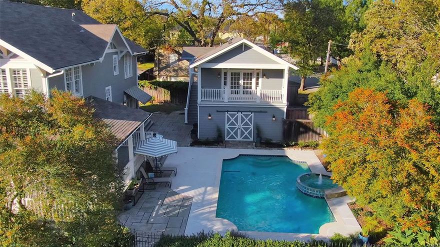 HISTORIC MCKINNEY's JACKSON-ATKINSON house, built in 1914, has been beautifully renovated and is situated on one of McKinney's most desirable streets: 1204 Tucker Street. The corner lot provides an expansive front yard and a newly constructed (2023) 730 sq.ft. oversized, detached garage facing the side street. A 600 sq.ft. CARRIAGE HOUSE is situated atop the garage, featuring a balcony overlooking the pool and courtyard. A rebuilt and widened walkway, constructed with reclaimed red bricks, leads to the inviting wrap-around porch and front door. The recently remodeled interior boasts a designer kitchen ideal for entertaining, complete with a large center island, ample cabinet storage, and Carrara Marble countertops. It includes a Bertazzoni 5-burner cooktop convection oven and vent hood, a large farmhouse sink and faucet, custom ceiling-high kitchen cabinets with inset lighting, and a spacious walk-in pantry. Additionally, there is a cozy sitting area off the kitchen and French doors that lead to the side porch and a tranquil POOL with spa. Both the primary and downstairs bathrooms have also been beautifully remodeled with Carrara Marble tile floors, showers, and countertops. This two-story craftsman home, despite renovations, retains its original character. It features original pine and oak floors, craftsman-style door knobs, solid 5-panel doors, exposed shiplap, antique chandeliers, and custom crown molding and baseboards. New gas lines and plumbing were installed between 2018 and 2019. French drains were added around the exterior of the house in 2025. There are a lot more surprises, so be sure to review the 2-page List of Remodels, Upgrades & Improvements available in MLS documents! We also have a History Report on the house and printed floor plans for the main house, garage, and carriage house. The popular Downtown Square, with its shopping, dining, art galleries, and seasonal events, is conveniently located and easily accessible by foot, bicycle, or golf cart.