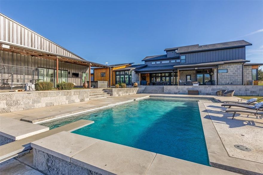 A True One of a Kind Estate in one of Decatur's most desired locations! Luxury Main Home, Modern Pool House, Insulated Shop with oversized diving pool on 6.33 fully secluded Ag-Exempt acres! Rare blend of luxurious living, resort-style amenities, and endless possibilities. Nestled in peaceful seclusion, this exceptional estate offers unmatched privacy, space, and self-sufficiency. Spacious 3,972 sqft primary residence boasts 4 generous bedrooms each with a private en-suite bathroom and walk-in closets.  Primary suite features a wet room with illuminated jetted soaking tub, expansive closet with his and her dressing areas with direct access to utility room.The open-concept design floods the home with natural light, creating an inviting flow from the gourmet kitchen with butlers pantry to the great room. Highlights include a dedicated media room for movie nights or gaming, a secure safe room for peace of mind, a large covered patio perfect for year-round outdoor entertaining, and a sparkling large pool that serves as the centerpiece of resort-like backyard living. Practical luxury shines through with well water sourced from 2 wells, including a water storage tank and constant pressure booster pump for reliable, high-volume supply. 2-car garage provides ample parking and storage. Complementing the main home is a modern 2,051 sqft pool house, a stylish 3 bedroom, 2 bath guest retreat featuring an open concept layout with open loft. Ideal for multi-generational living, guests, rental income or a home office. No detail is overlooked: a massive 35x40 insulated shop (with 2 oversized 12x12 overhead doors, 10x50 cover awning) offers endless potential for vehicles, equipment, hobbies, workshops, or additional storage. Property is fenced, crossfenced. Pride of ownership is evident throughout this move-in-ready estate. Don't miss this extraordinary opportunity!