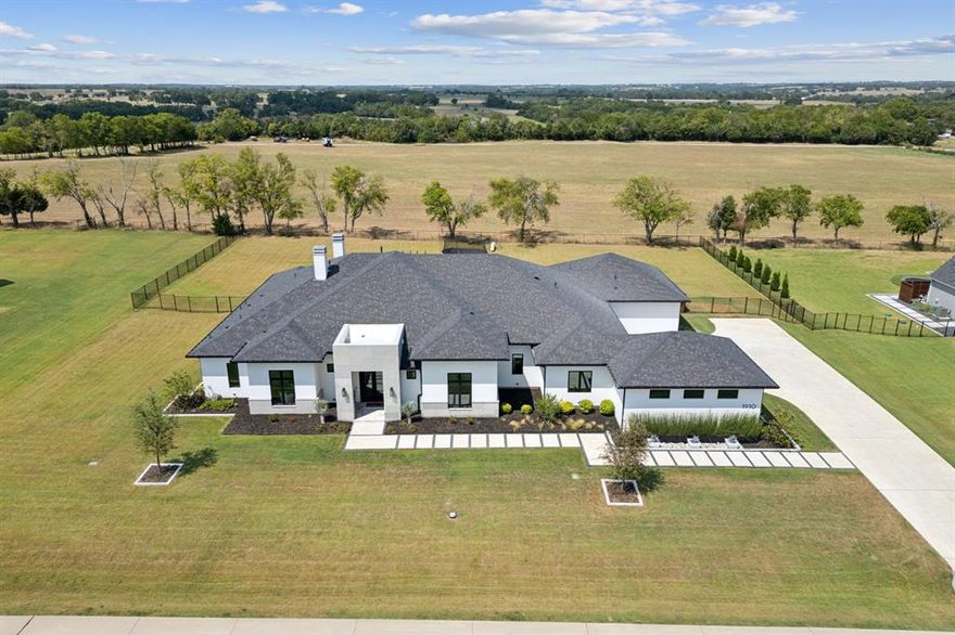 Welcome to this meticulously crafted custom home, embodying luxury & modern design on a spacious 1-acre lot. This residence blends sophistication & comfort seamlessly. The exterior features upgraded stonework, painted white brick, & Stucco.  A grand double iron & glass entry door opens to an interior w wide-planked white oak floors throughout. A climate-controlled, insulated glass wine display is a show-stopper. The living area, w a sleek fireplace, blends indoor & outdoor spaces through double sliding doors with pool views. The gourmet kitchen boasts quartzite countertops, a waterfall island, & high-end Thermador appliances. The primary suite offers a coffee bar w refrig, luxury closet, marble flooring, & frameless shower. The floor media room is soundproof, w 4 additional ensuite bedrooms, a study, & an upstairs bonus room. Outdoor living includes a covered patio, motorized screens, heaters, & 38,000-gallon saltwater pool & spa. 4-car garage w storage, sprinkler system.