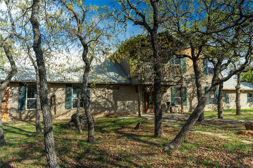 This is a fantastic example of a Clayton Mountain Hill Country Style Home! With a massive towering ceiling that greets you the moment you walk through the front door, a full wall of windows overlooking the nature park behind the home, and rustic finishes throughout, you’ll never want to leave! The home features custom woodwork, cedar trim details, stained concrete floors, tons of built-in custom cabinetry, huge kitchen space, and more! On the outside, you will find a full stone exterior with a metal roof. In the backyard, you will enjoy overlooking a peaceful pond frequented by deer, turkey, and aoudad that is also stocked with fish and ready to enjoy. The pond is located in the community hiking area, the home backs up against that, and features miles of hiking trails with over 200 acres of space to explore. If you’re yearning for a hill country style getaway but would love to find something closer, please note that this one is only an hour west of Fort Worth! The home is located in a gated resort community full of premium amenities, hiking trails, fishing lakes, riding stables, and more! Perfect for full-time resort-style living or an amazing getaway home that someday might turn into your primary residence! Sellers are motivated…don’t miss the chance to buy now and begin to immediately enjoy a lifestyle that is unimaginable to most! Please note that the walk-in tub shown in the pictures will be removed and replaced with a typical tub-shower unless negotiated differently.