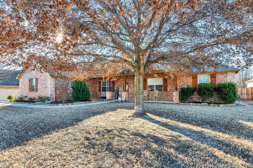 Updated and move in ready 1 story 4 bedroom 2 bath home on half an acre! This home features an open floor plan with 12ft ceilings, beautiful hardwood floors, a spacious family room with a fireplace, eat in kitchen with granite counter tops, tile back splash, electric cook top, and an abundance of great counter and cabinet space, and a formal dining room. Private primary suite includes a jetted tub, walk in shower, dual sinks, and a walk-in closets. The 3 additional bedrooms are down the hall and are nice size, they share a bathroom with dual sinks and a tile shower. This home also has a 3 car garage and an extra wide driveway with access to the backyard. The backyard is inviting with a covered patio, built in grill, room to add a smoker, and plenty of space to relax and entertain.