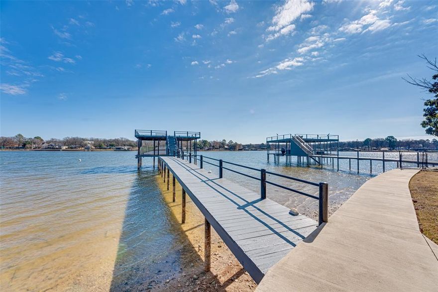 Spectacular one story ranch style lakefront home situated on wooded cul-de-sac lot with a ton of parking in highly sought after Enchanted Oaks at Cedar Creek Lake.  Enchanted Oaks is where only site-built homes are permitted to preserve value and appeal. The residence enjoy access to the community pool, playground, dog park, boat launch and boat storage areas.  This home features 3 spacious bedrooms one of which is a bunk room that sleeps 6, 2.5 baths, a flex space, and 3 living areas including large game room with wood beamed vaulted ceilings, custom built-ins and Plantation Shutters.  The family room offers a stone WBFP and an effortlessly flows to the second living area with an abundance of windows overlooking open water and the huge wrap around deck with gazebo.  Enjoy endless breathtaking views of the lake with eastern facing morning sunrise, firepit, and recently updated boat dock with party deck including boat lift plus PWC lift and covered porch area!  The opportunities are endless would make a perfect primary home, second home, vacation home that is great for entertaining both family and friends.  Many recent updates including roof in 2025, dock tune up 2025-2026, steel retaining wall 2020, landscaping 2024.  Please see Transaction Desk for details and receipts.