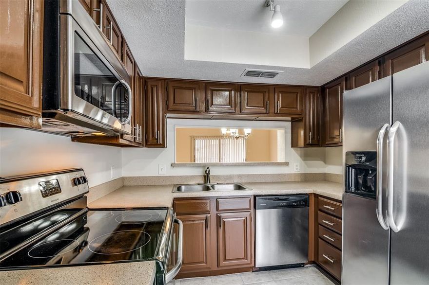 Step away from the city’s constant hustle and unwind in you own peaceful retreat in the heart of Irving. This charming first-floor condo is ideally located just minutes from the vibrant Las Colinas district. Inside, you’ll find a well-designed two-bedroom, two full bath layout with a spacious living and dining area. The kitchen showcases warm wood cabinetry and sleek stainless steel appliances, offering both style and ample storage. Two private patios—one off the living room and another off the primary bedroom—create the perfect spots to unwind. Set within a gated, beautifully maintained community, residents enjoy a full suite of amenities, including a pool and hot tub, a fully equipped fitness center, and a welcoming clubhouse for social gatherings. Live with confidence in a secure community with on-site security and meticulous upkeep. The monthly HOA covers essential services such as water, hot water, trash, exterior and roof maintenance, and grounds keeping—making for truly low-maintenance living. Just minutes away, you can catch live entertainment at the Toyota Music Factory or explore top-tier shopping and dining options. Conveniently located near DFW International Airport, this condo offers the perfect blend of comfort, style, and accessibility. Don’t miss your chance to enjoy elevated living in a prime location—schedule your private showing today!