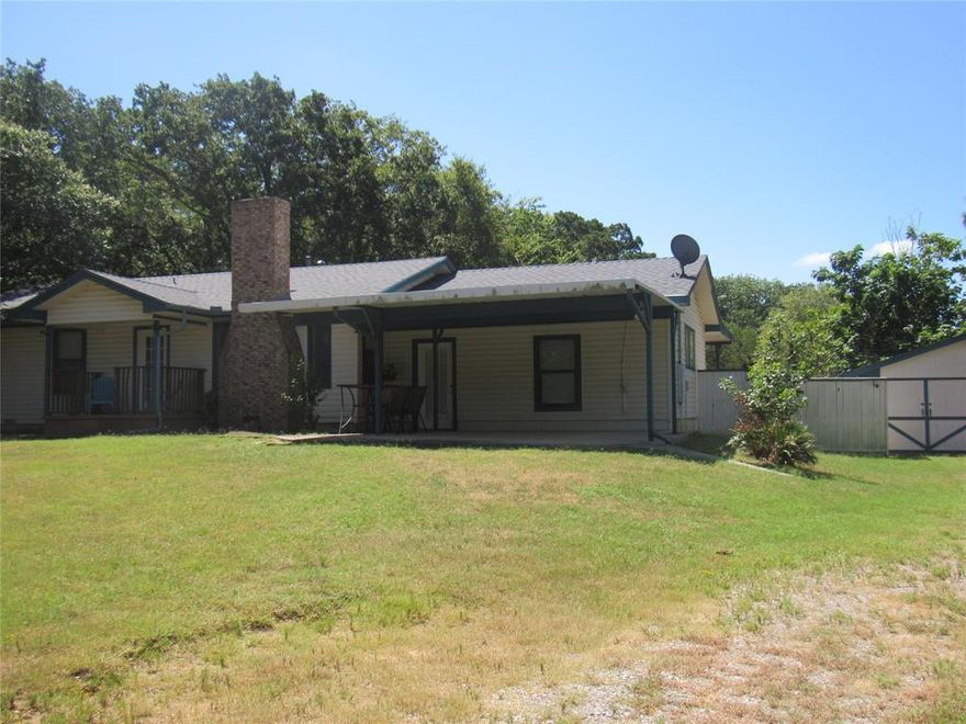 PEACE AND QUIET OF THE LAKE, MINUTES FROM THE HUSTLE OF SHERMAN AND WITHIN 45 MINUTES OF THE METROPLEX.  LAKE VIEWS ACROSS HOMESITE ROAD, THIS HOME SITS ON TOP OF A RISE IN THE MIDDLE OF ALMOST AN ACRE OF LAND.  HAS BEEN USED AS A VRBO IN THE PAST AND IS STILL SET UP AS SUCH, 5 BEDROOMS WITH THE POSSIBILITY OF ONE MORE, 3 FULL BATHS, HUGE BACK ROOM CURRENTLY SET UP AS DOUBLE DINING AREA, SMALL LIVING AREA IN FRONT WITH A GREAT WOOD BURNING FIREPLACE.  WELL, CO-OP WATER, THE GARAGE HAS BEEN USED AS A GREAT PARTY BARN, BUT CAN STILL USE AS GARAGE IF YOU WANTED TO DO SO.  LUXURIOUS BACK PORCH RUNS THE LENGTH OF THE BACK OF THE HOME, WITH A NICE COVERED PORCH TO THE SIDE OF THE DECK AND HOME.  BEAUTIFUL YARD, WHAT A FUN INVESTMENT OR, LIVE IN, FULL TIME, PART TIME, LIVE IN WHILE BUILDING YOUR DREAM HOME .... OH THE POSSIBILITIES!   COMPLETE REMODEL A FEW YEARS AGO, YOU SURE NEED TO TAKE A FEW TO TOUR THIS HOME, ENJOY THE LAKE LIFE ! 
FURNISHINGS NEGOTIABLE, Yes, furnishings can be negotiable. 

New roof on both house and shed in 2023. New floors in the kitchen, two bathrooms and hallway leading to the back bedrooms. 
The property has a well pump that goes down 150ft or 200 ft. The well pump was broken when bought the house. This is located in the little shed that is near the shed. 
BUYERS TO VERIFY ALL INFO IS ACCURATE
