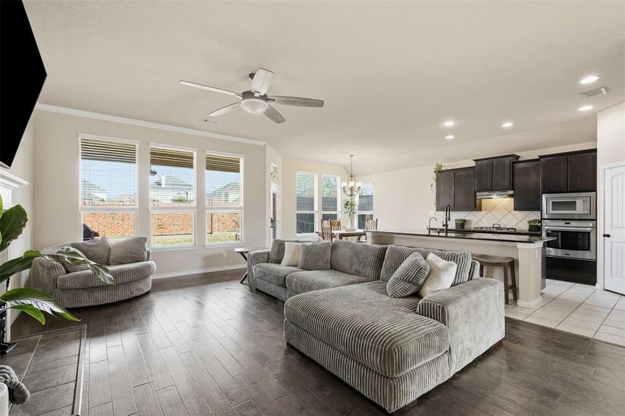 Nestled in Summer Creek South, and located on a premium corner lot of this desirable community with access to a sparkling community pool, is the gem of a home. This home features a spacious open-concept layout perfect for modern living. Upon entry, a wide foyer sets a warm and inviting tone, leading to a flexible 4th bedroom ideal as a home office or guest room. The heart of the home is a large family room with rich hardwood flooring, abundant natural light, and a cozy tile-accented fireplace. The adjoining kitchen is a chef’s dream with granite countertops, dark wood cabinetry, a generous center island with bar seating, stainless steel appliances, gas cooktop, and a built-in oven and microwave. Retreat to a private backyard enclosed by a stunning full brick wall, offering privacy and security. The curb appeal is unmatched with a brick-and-stone elevation, lush landscaping, and a double driveway with swing garage. Situated in a peaceful neighborhood with easy access to shopping, dining, and schools, this home is perfect for first-time buyers or anyone seeking comfort and convenience. You will love this home for years to come.