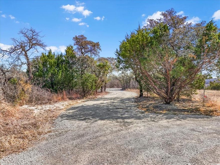 Build-ready 1.2-acre lot on Valley View Court in the Land of Goshen subdivision. Electric, septic, and a water meter are already installed, saving buyers significant time and development expense. The property also includes an improved homesite with a gravel pad in place. A portion of the land has been cleared with additional rock brought in, helping reduce the time and cost to start building. Barndominiums are allowed. This hilltop property faces west and offers beautiful views, peaceful sunrises, native trees, and abundant wildlife, with rear access available through High Country Court for added flexibility. Enjoy the privacy of country living while being approximately 30 miles from downtown Fort Worth, located within Springtown ISD.