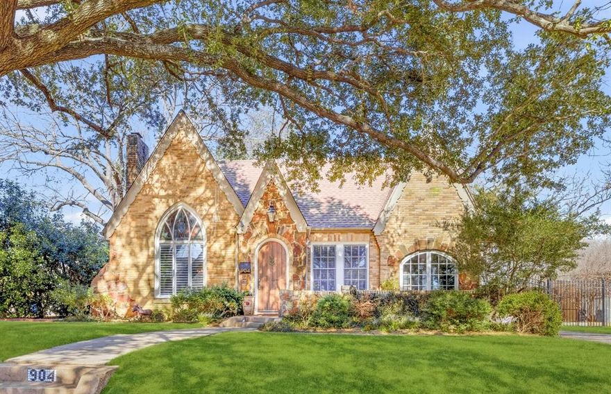 Set on an exceptionally rare double lot in the heart of Hollywood Heights, this 1930 brick and stone Tudor is a masterclass in timeless character paired with thoughtfully curated modern luxury. With undeniable presence and scale, the home offers three bedrooms, two baths, and a layout that feels both intimate and expansive.
The living room is nothing short of striking, anchored by a dramatic 12-foot vaulted ceiling, a statement fireplace, and an original stained-glass window that filters natural light in jewel-toned hues. Rich hardwood floors flow throughout, creating warmth and cohesion across living and entertaining spaces.
The kitchen is designed for both beauty and performance, featuring 9-foot ceilings, custom cabinetry, and a suite of top-tier appliances including Wolf, Sub-Zero, and a built-in Miele coffee system. Carrara marble surfaces, a generous pantry, a dry bar, and seamless access to the outdoor living areas make this space equally suited for everyday living and elevated entertaining.
The primary suite offers a private retreat with a custom walk-in closet and serene outlooks, while the two guest bedrooms are connected by a charming Jack-and-Jill bath that allows for flexible living. A dedicated laundry and utility room adds functional ease rarely found in homes of this era.
Outdoors, the property truly distinguishes itself. The expansive grassed yard is framed by mature trees and features an enclosed back patio for year-round enjoyment, a bocce ball court along the side yard, and ample space for entertaining or play. A detached two-car garage is complemented by a recently updated approximately 400-square-foot guest quarters complete with a full bath and air conditioning, ideal for visitors, a home office, or a creative studio.
This is a home where architectural charm, thoughtful updates, and rare land value converge, offering a lifestyle that is as refined as it is inviting. A true Hollywood Heights standout with character to spare.