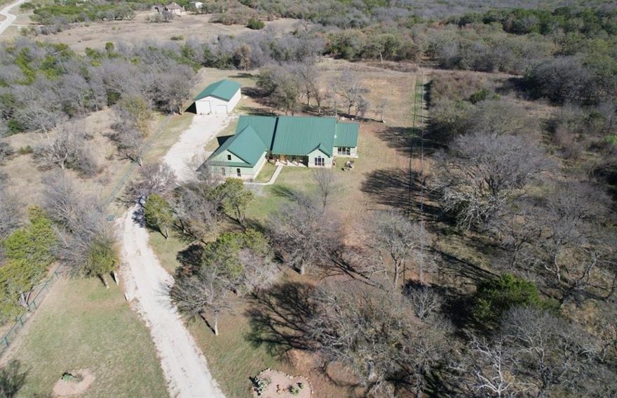 Built for buyers who value systems over finishes, this 3,000+ sq ft, one-story custom home , with a fully outfitted insulated shop sits on over 5 partially wooded acres with a dry creek and daily wildlife. The front three acres are fully fenced with 5-foot fencing and hog wire buried one foot deep, designed to block feral hogs while allowing deer and turkey movement. A solar-powered automatic gate controls access. Built in 2022, the property was designed for long-term performance, resilience, and control.
Construction includes an engineered slab with oversized beams and additional rebar, closed-cell foam insulation, and a hail-resistant metal roof. The home is fully wheelchair accessible and consists of a concealed FEMA-rated safe room. Mechanical systems feature Trane HVAC with heat pump and gas backup, ERV fresh-air exchange, whole-home dehumidifier, instant hot water loop, carbon water filtration, insulated PEX plumbing, LED lighting, and a Generac whole-house backup generator supported by a buried 1,000-gallon propane tank.

The open floor plan includes an eat-in kitchen & living room anchored by a large stone gas fireplace. The kitchen features a gas range with hood, refrigerator, dishwasher, wall oven, microwave, and an ice maker. The laundry room includes a washer, dryer, and a full-size refrigerator. A bonus family room offers flexible use as a sunroom, game room, workout room, playroom, or craft room, complete with cabinetry and a sink. An oversized epoxy-coated 3-car garage includes an additional 500 sq ft of built-in storage cabinets. The covered back patio has a built-in gas grill and a sink. 
A 1,900 sq ft insulated, plumbed, and fully wired shop with an automatic RV-height door, front and rear overhead doors, water, internet, and hookups functions as a true secondary asset. This property is in The Hills Above Possum Kingdom with a community pool, dock. boat launch and boat storage.
If you understand replacement cost & infastructure it makes sense.