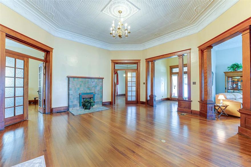 This 1913 gem is what your historic home dreams are made of! Rich in history and a focal point near downtown Winnsboro, this extraordinary 5-bed, 3.5-bath home spans 4,411 sq ft and offers a rare blend of historic elegance and modern updates. Two separate covered front porches each have their own entrance. Step inside the vestibule and into the rotunda to be captivated by the original Longleaf Pine floors, original grand mahogany pillars, and intricate staircase. The character of this home shines through with three original glass double doors, original light fixtures, functioning transom windows, and impressive 12-foot pressed tin ceilings. The main level features the primary suite with an oversized walk-in closet and a guest bedroom with an ensuite bath, both with fireplaces. Upstairs, you’ll find three additional bedrooms and a fully remodeled bath with a clawfoot tub. Two of the upstairs guest rooms have walk-out balconies, and one showcases beautiful original shiplap from top to bottom. This home has been thoughtfully upgraded for modern comfort, featuring a tankless water heater, foam insulation, a completely updated plumbing system from the house to the street, and upgraded electrical panels relocated to the basement. A 50-year shingle roof was installed in 2017, along with a sprinkler system and paid-off solar panels for energy efficiency. Additional highlights include zoned HVAC with four units, two spacious attics with floored storage space, and a basement with exterior access. Outside, enjoy the huge, fenced yard, mature trees, and a spacious covered patio with an outdoor kitchen and gas fireplace. There is a large recreation room complete with a bar, in addition to the carriage house that is two-cars deep. This is a one-of-a-kind opportunity to own a piece of history—updated for modern living! Special financing on this home-reach out for more info.