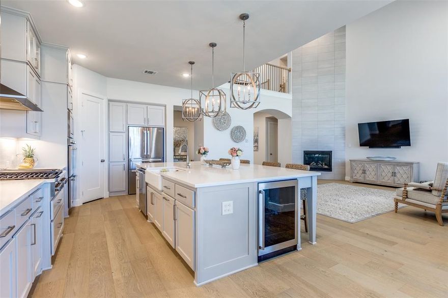 Seller is offering assistance with an interest rate buydown to help lower your monthly payment with an acceptable offer. 
Stunning east-facing 4-bed, 3 full bath, 2 half bath home on large corner lot in Mustang Lakes within the award-winning Prosper ISD. Designed with elegance and functionality for multi-generational, blended, or entertaining lifestyles, this home offers a first-floor primary suite, spa-style bath, decorative tile, soaking tub, tiled shower, split vanities, and custom closet with built-ins connecting directly to laundry room with wall-to-wall cabinetry and stainless sink. Private first-floor guest suite includes an en-suite bath and walk-in closet, perfect for visiting family or extended stay guests. Enjoy movie nights in the first-floor media room with new carpet, or work from home in the dedicated office. The gourmet kitchen includes an oversized quartz island, farmhouse sink, beverage fridge, professional-grade Electrolux appliances with a 6-burner gas range, double ovens, large microwave, soft-close drawers, custom pull-outs, spice rack, built-in desk, and abundant pantry storage. The open living room features a floor-to-ceiling tiled fireplace and double sets of windows that fill the space with natural light and sunset views. A central dining room with dry bar and wine fridge is ideal for entertaining. Upstairs includes a spacious game room, half bath, and two large bedrooms one with a private sitting area, Jack-and-Jill bath. Additional features include hardwood floors on the main level, custom lighting, plantation shutters, tinted upper windows, a 3-car garage, covered patio with gas line for grilling, and a wrought-iron gated side yard perfect for pets or gardening. Mustang Lakes amenities include scenic trails, lakes, pools, fitness center, clubhouse, tennis courts, and playgrounds. Experience resort-style living in this turnkey Prosper ISD home featuring a first-floor guest suite, first-floor media room, large kitchen, and private office.