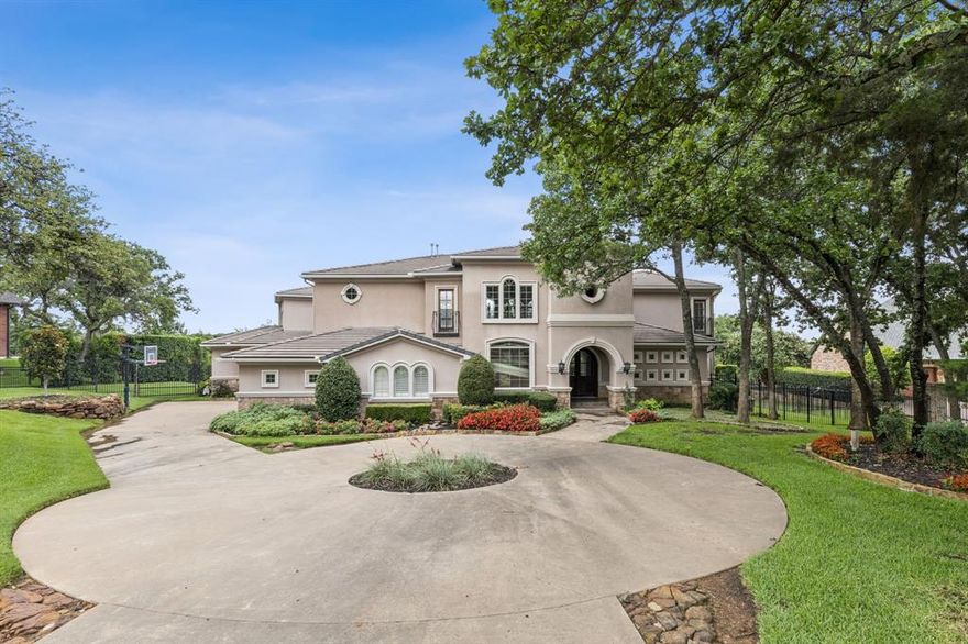 BEAUTIFUL MEDITERRANEAN LAKESIDE ESTATE IN POINT NOBLE OF FLOWER MOUND. GORGEOUS VIEWS OF GRAPEVINE LAKE & CORE OF ENGINEERS GREENBELT. This is a rare opportunity to own a home at this location in the PREMIER GATED COMMUNITY of POINT NOBLE.
This Mediterranean villa features gorgeous euro architectural design with stunning views from every living area and the primary suite. The home, terrace and swimming pool feature private living and entertainment space, with elevated views above the beautifully landscaped yard, Corp of Engineer's property and Grapevine Lake. Fantastic location in a fantastic community with excellent schools. Must see!