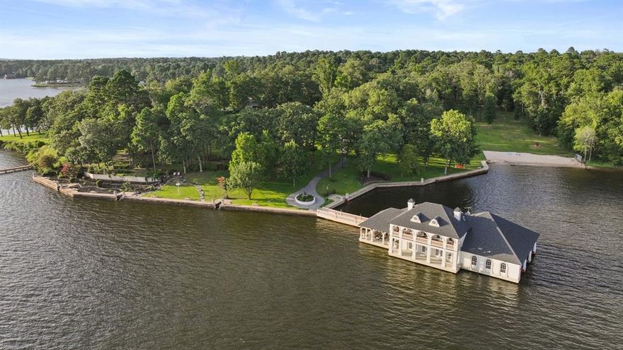 Unrivaled Waterfront Estate on Lake Tyler – Live in the Luxurious Boathouse or Build Your Dream Home!

This breathtaking 5.9-acre property offers 715 feet of prime shoreline with a concrete bulkhead and a scenic sidewalk running along the water's edge. Panoramic lake views on open water, and your own private white sand beach, the ONLY beach of its kind on Lake Tyler. Extremely rare to find this much acreage on this lake. Build as big of a home as you desire.

The estate includes a 5,811 sq ft under roof high-end boathouse designed for luxurious living and entertaining—featuring covered porches and balcony, an outdoor spa, 3 boat garages, a floating dock, and upscale finishes throughout.

Plus, enjoy a 1,760 sq ft heated and cooled 3-car garage and workshop with ADA-compliant guest quarters—totaling 7,470 sq ft under roof perfect for guests or income.

The grounds are truly special: massive concrete retaining wall, hardwoods, pines, rock waterfall, life-size bronze statues in gardens, azaleas, and a grand stone gated entry with a 6 ft thick, 20 ft wide lighted driveway.

No detail spared—whole-home generator, French drains, lifetime rubber roofs, Timbertec decking, gas lanterns, Lutron smart lighting, built in Sub-Zero, Thermador gas range and 2 warming drawers, Insta-hot water, ice maker, Taj Majal countertops, Quartz Workstation Sink with touch faucets plus a separate bar sink, motorized shades, smart locks, smart irrigation from lake, integrated sound system, LED 4K Projector and motorized screen in Media room (which can also be 3rd bedroom), gas stone fireplace with an electric switch starter, Toto bidets, 2 Boat-lifts and 1 Water-Craft lift, all 3 with Overhead roll up garage doors, an outdoor shower at the beach, and much more.

This is more than a lake property—it’s an exquisite lifestyle on Lake Tyler unlike any other.