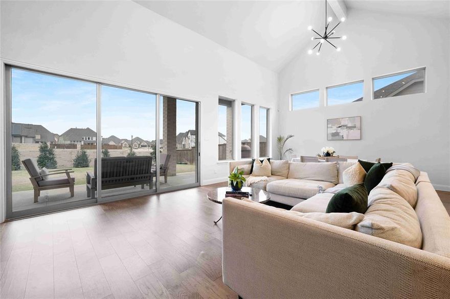 60’ LOT + DREES BUILD + MOVE-IN READY — SELLER OFFERING 2-1 RATE BUYDOWN RESULTING IN ~$660 a MONTH IN SAVINGS IN YEAR ONE ($8,000) and ~$340 a MONTH IN SAVINGS IN YEAR TWO ($4,000) WITH ACCEPTABLE OFFER. 1909 Century Lane stands out for what today’s buyers actually care about—more space, meaningful upgrades, and true move-in readiness without the delays or hidden costs of new construction. With 5 bedrooms, 4 bathrooms, and zoning to McKinney ISD, one of the top school districts in Texas, this is one of the best values you’ll find in Trinity Falls—and the price reflects it. premium 60’ lot, offering a larger backyard and outdoor space that’s increasingly hard to find at this price point. Comparable homes in Trinity Falls with this lot size, builder pedigree, and level of finish are commanding significantly more, making this a rare opportunity to get more home for your money without compromising on quality. A dramatic floor-to-ceiling sliding glass wall anchors the main living area, filling the home with natural light and opening seamlessly to a covered patio. Built-in speakers extend from the living room outdoors, creating a setup that works as well for everyday living as it does for entertaining. The kitchen features a 5-burner gas cooktop, double ovens, and an oversized walk-in pantry with ample space for small appliances. The mudroom and utility spaces carry cohesive, upgraded finishes throughout. The primary suite offers a retreat with a frameless glass shower with dual heads, soaking tub, quartz counters, and spacious walk-in closets. A secondary ensuite bedroom on the main level provides flexibility for guests or multigenerational living. Upstairs, a surround-sound-wired bonus room functions easily as a media room, game room, or private suite with its own full bath. Residents enjoy access to resort-style amenities including pools, fitness facilities, co-working spaces, 350 acres of trails and Old Joe Dog Park—a rare combination of lifestyle and convenience.