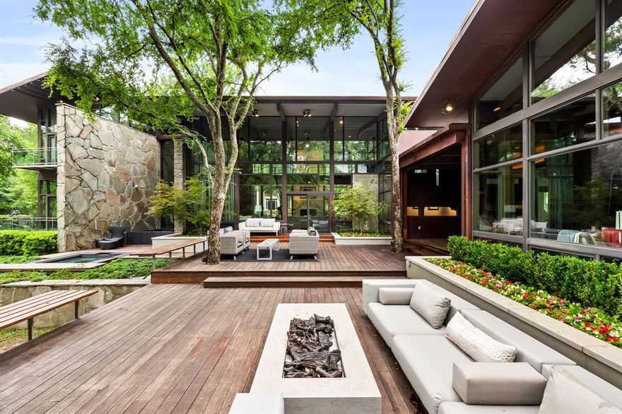 Welcome to one of University Park's most stunning contemporary homes ever built. Nestled on a remarkable 0.432-acre lot surrounded by mature trees, this home feels like a true treehouse retreat. Designed by noted Dallas architect Gary Cunningham, with the interior design by Trisha Wilson, every room is exceptional. Featuring a three-car garage, radiant heated floors throughout the main level, and stunning gallery-style windows, this home is truly a masterpiece.