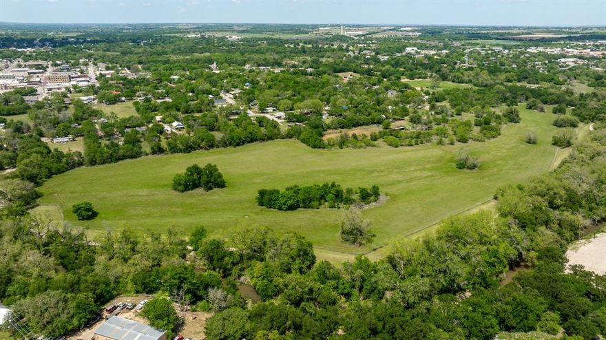 Discover an exceptional investment opportunity with this expansive 24.8-acre parcel, ideally situated within the city limits. This unique property boasts the rare advantage of being bordered by the ever so popular Bosque River Walking Trail, offering a blend of natural beauty and urban convenience. Zoned B-3 Central Business, the land presents a wide array of development possibilities, limited only by your imagination. The location is perfect for constructing high-density apartments to meet the growing demands, or you could develop a housing community that attracts residents. With direct access to the walking trail and the river, future residents will enjoy outdoor activities right at their doorstep, enhancing the property's appeal and value. Investing in this property means capitalizing on a prime location with flexible zoning, promising substantial returns. The combination of natural amenities, accessibility, and central business zoning makes this an unparalleled opportunity to shape a significant part of the city's future. Don't miss out on the chance to transform this land into a thriving residential or commercial hub.